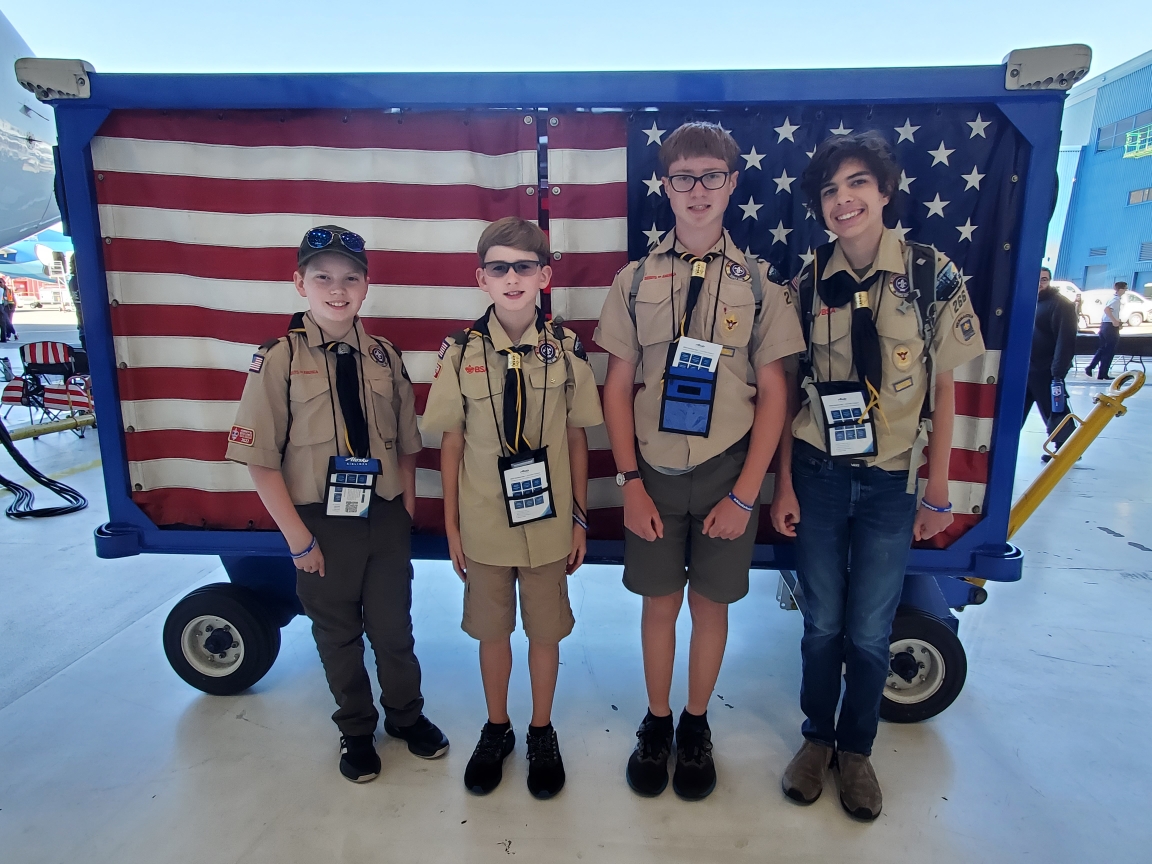 Scouts standing in front of the American flag.