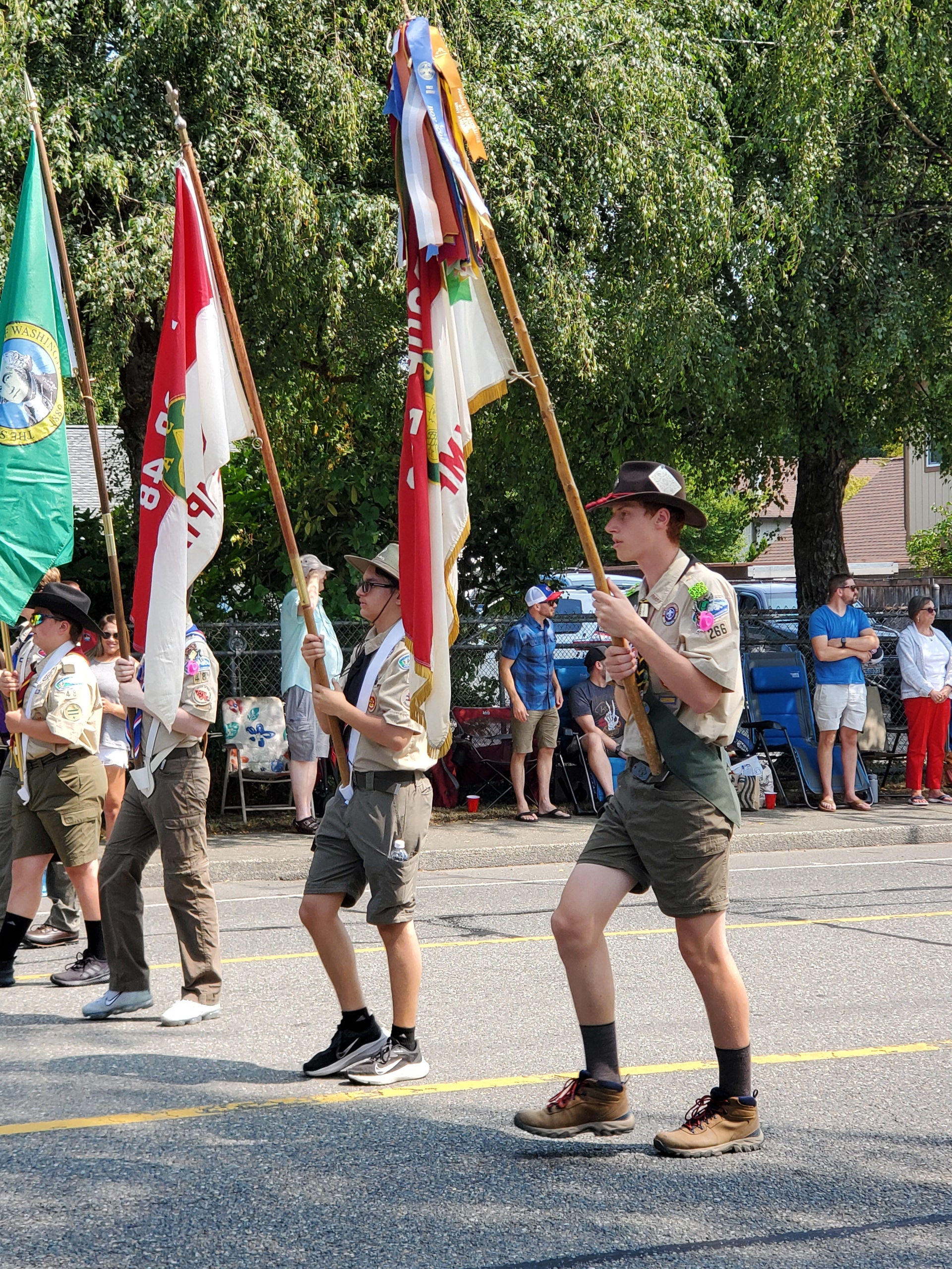 Scout holding the troop flag in the parade.