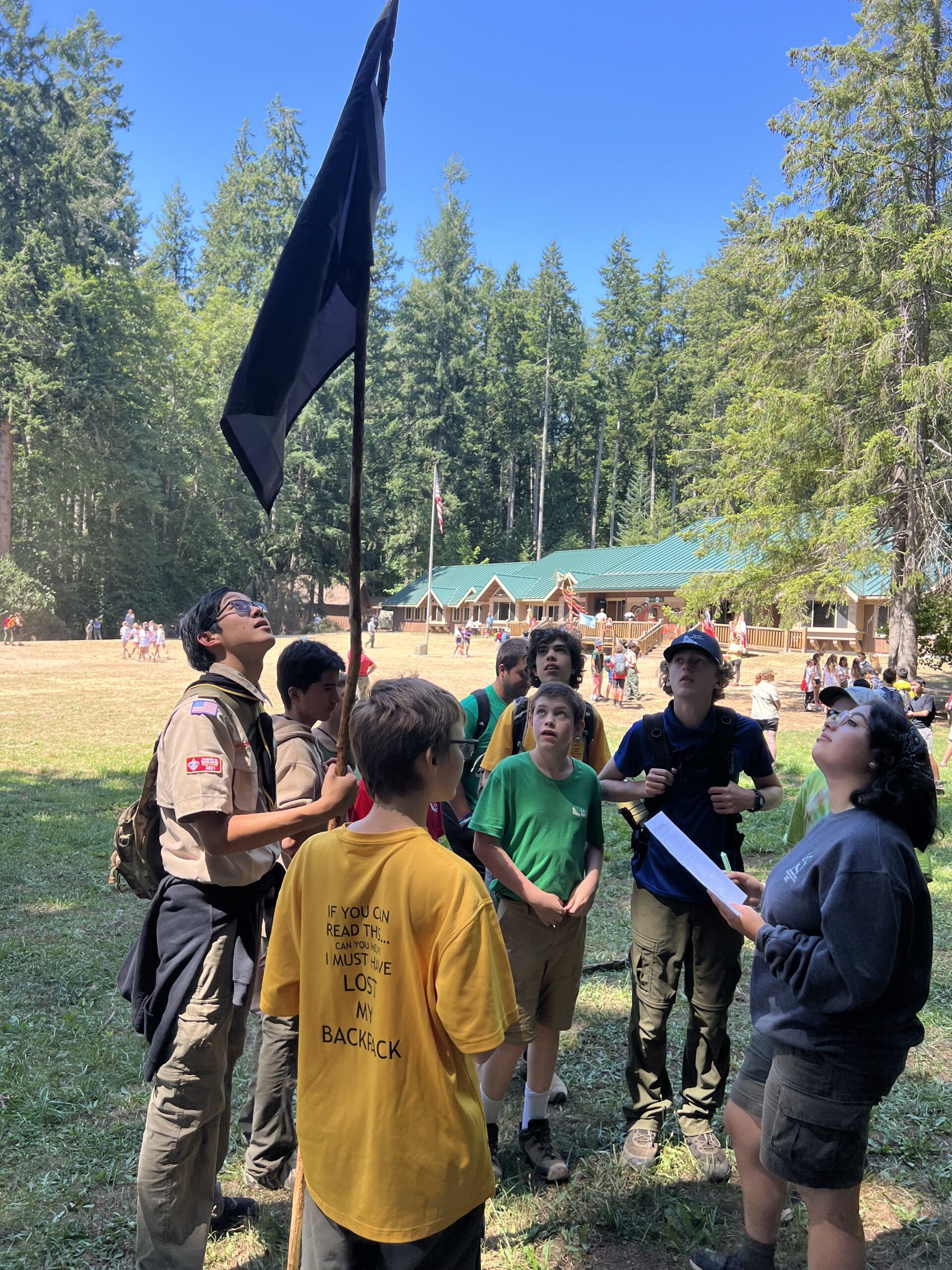 Scouts looking up at a flag