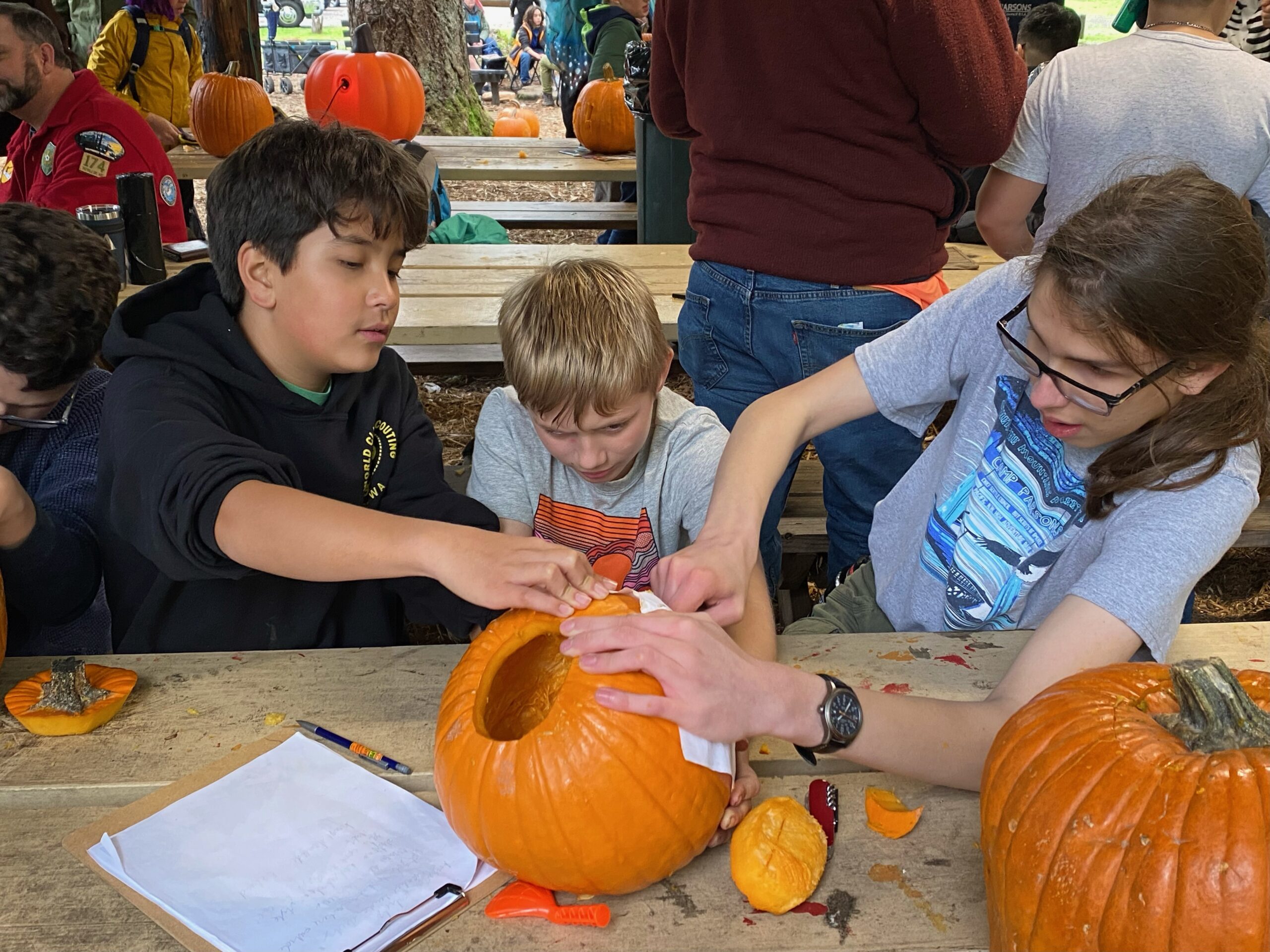 Scouts carving pumpkins