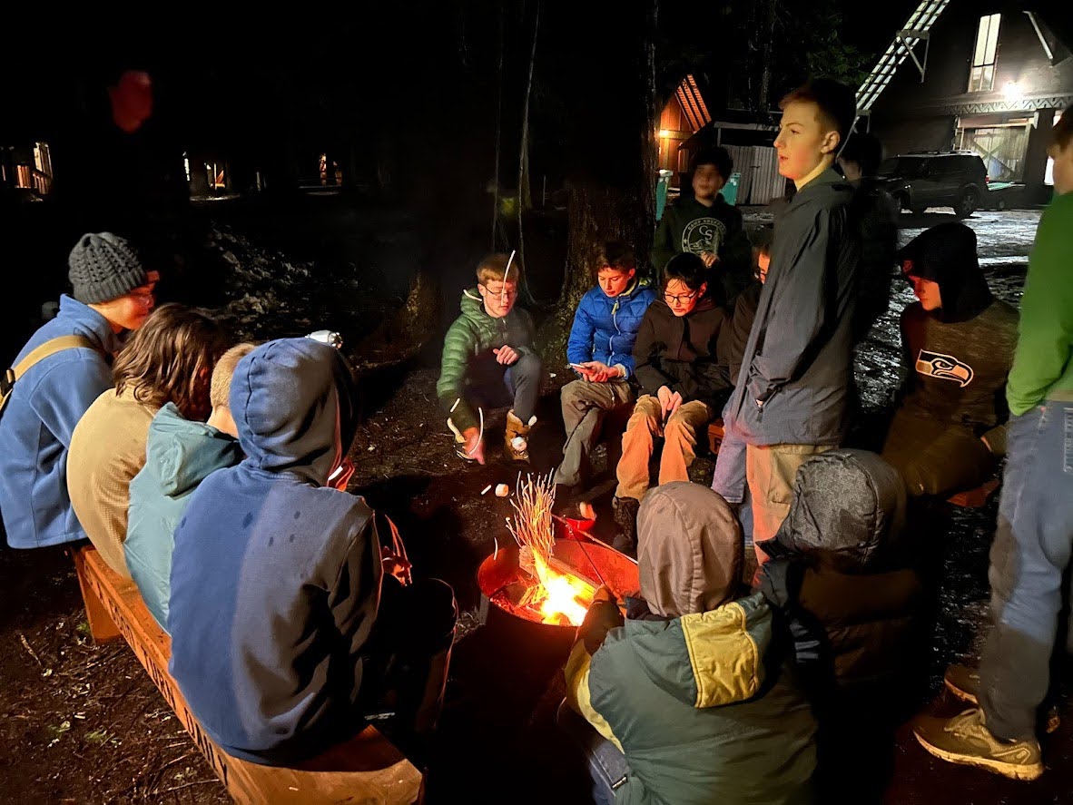 Scouts sitting by a campfire