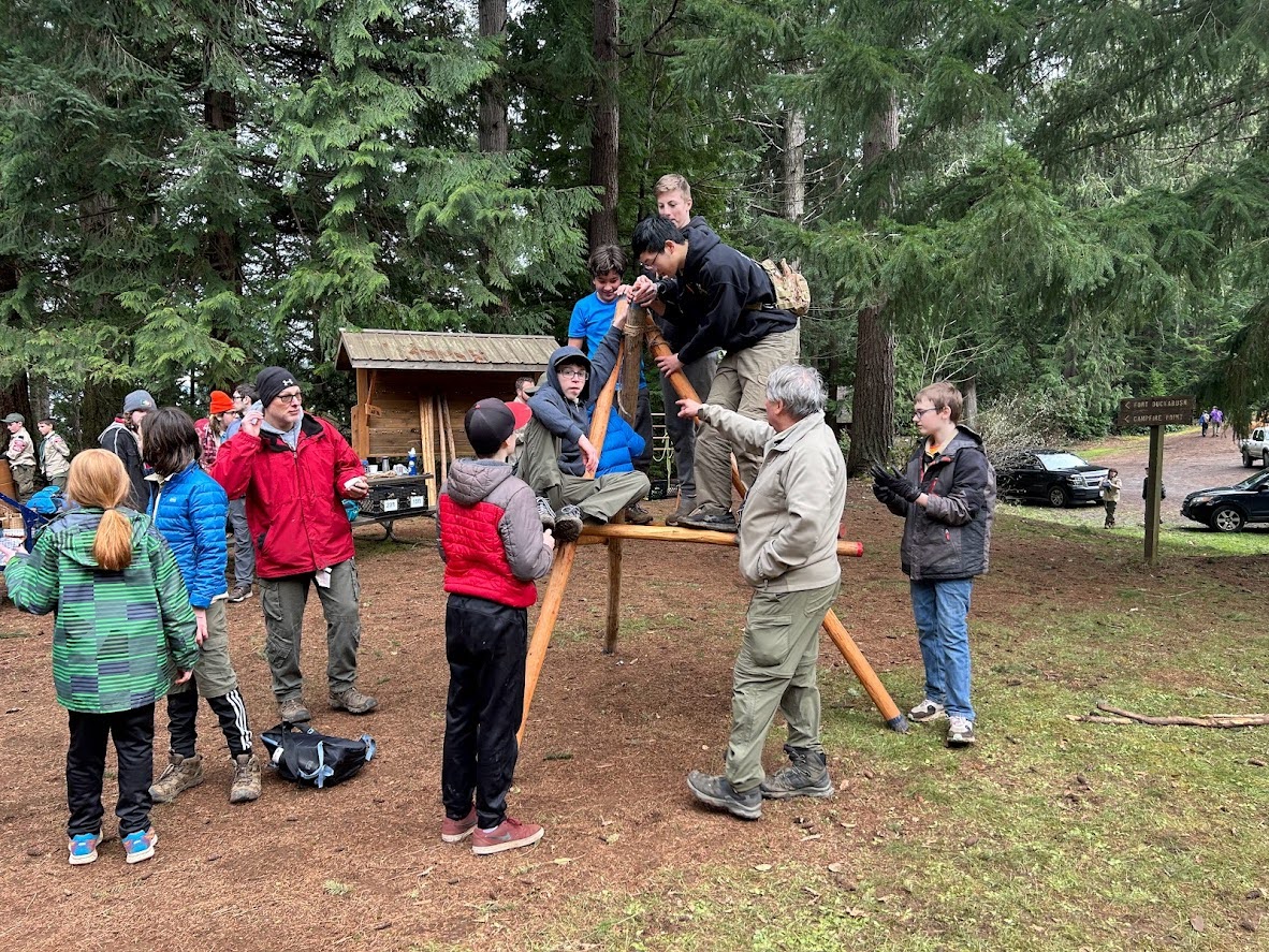 Scouts building a tipi structure